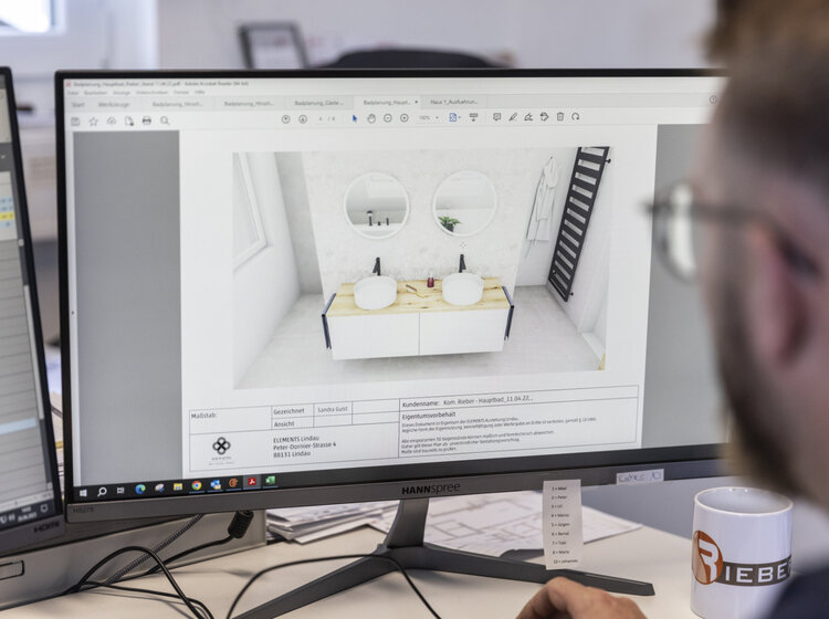 Rieber Mitarbeiter plant ein Badezimmer am Computer mit Software